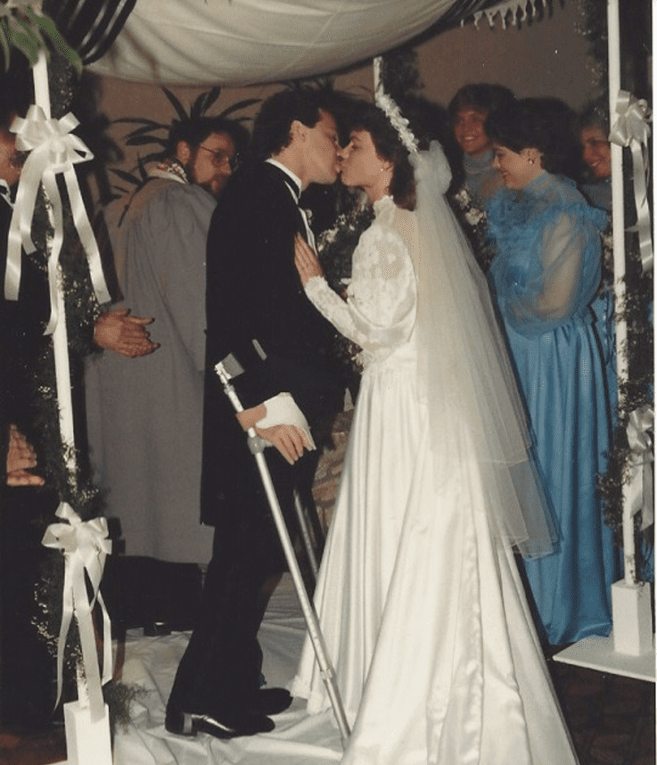 Married couple at the altar, man with crutches