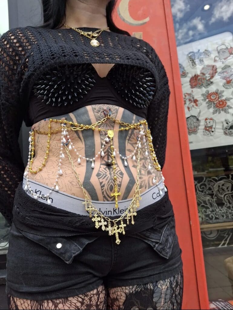 Image of gold and pearl body chains attached