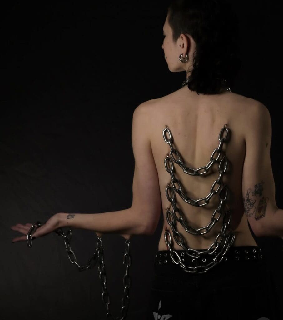 play piercing with chains down back