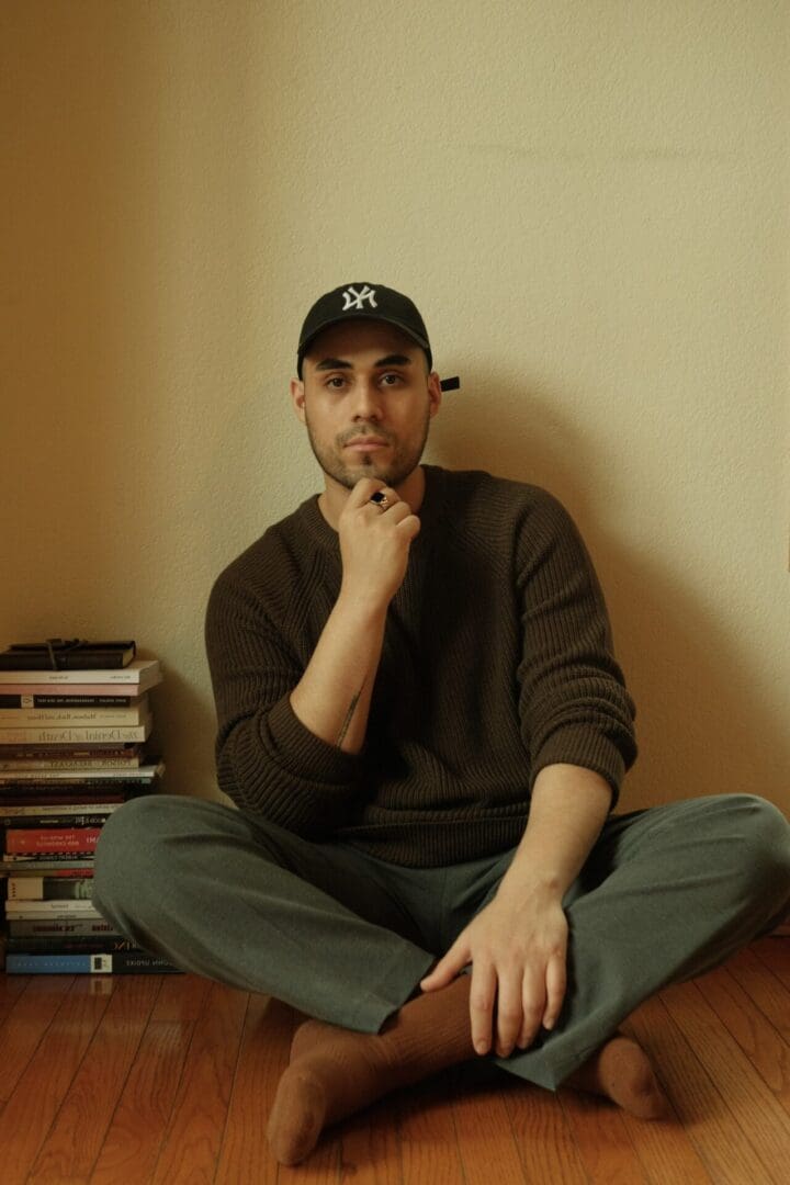 man sat on the floor with books