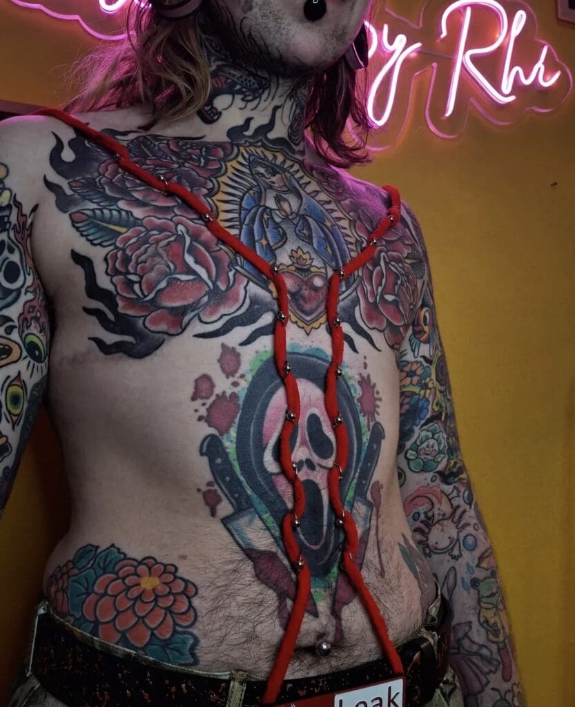 play piercing of red rope on chest